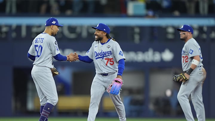 Oct 31, 2025; Toronto, Ontario, CAN; Los Angeles Dodgers shortstop Mookie Betts (50) and center fielder Justin Dean (75) celebrate after defeating the Toronto Blue Jays during game six of the 2025 MLB World Series at Rogers Centre. Mandatory Credit: John E. Sokolowski-Imagn Images