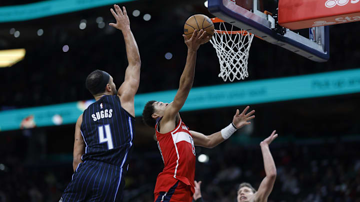 Washington Wizards guard Jordan Poole (13) shoots the ball as Orlando Magic guard Jalen Suggs (4) and Orlando Magic center Moritz Wagner (21) defend in the second half at Capital One Arena.