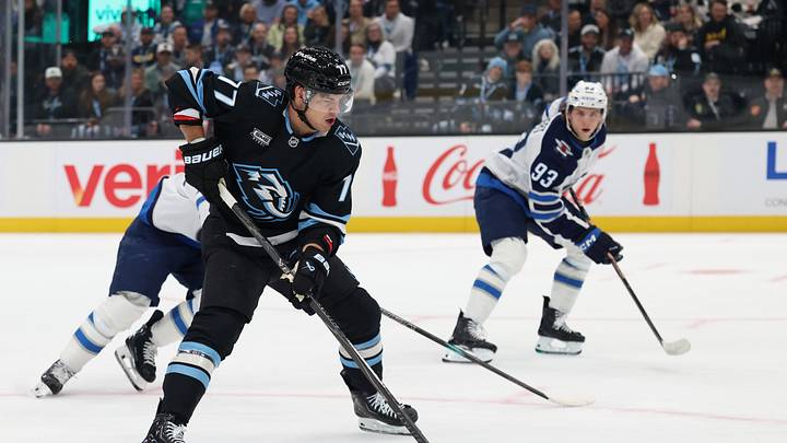 Apr 14, 2026; Salt Lake City, Utah, USA; Utah Mammoth right wing JJ Peterka (77) plays the puck against the Winnipeg Jets during the first period at Delta Center. Mandatory Credit: Rob Gray-Imagn Images