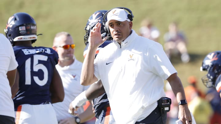 Oct 12, 2024; Charlottesville, Virginia, USA; Virginia Cavaliers head coach Tony Elliott (center) looks on fromt the field during a stoppage in play against the Louisville Cardinals during the first half at Scott Stadium. Mandatory Credit: Amber Searls-Imagn Images