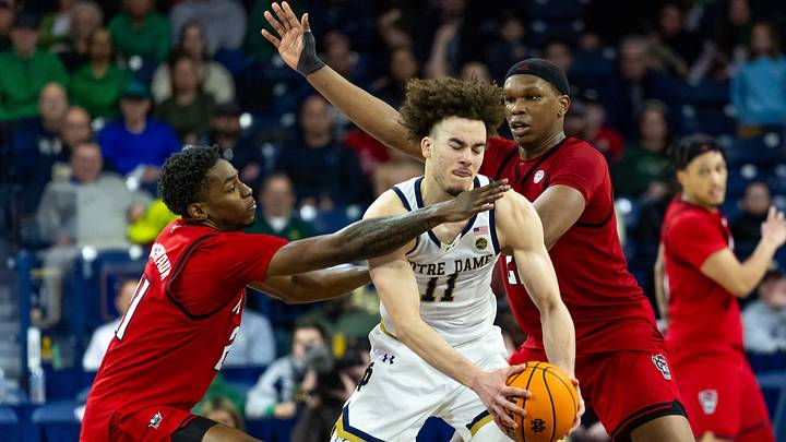 Feb 28, 2026; South Bend, Indiana, USA; NC State Wolfpack guard Terrance Arceneaux (21) and forward Ven-Allen Lubin (22) defend Notre Dame Fighting Irish guard Braeden Shrewsberry (11) during overtime at Purcell Pavilion at the Joyce Center. Mandatory Credit: Michael Caterina-Imagn Images