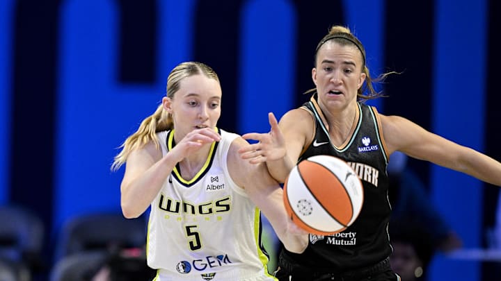 Dallas Wings guard Paige Bueckers is fouled by New York Liberty guard Sabrina Ionescu.