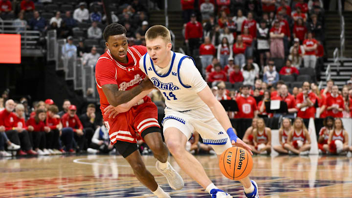 Mar 9, 2025; St. Louis, Missouri, USA;  Drake Bulldogs guard Bennett Stirtz (14) drives to the basket as Bradley Braves guard Duke Deen (21) defends during the second half of the Missouri Valley Conference Tournament Championship at Enterprise Center. Mandatory Credit: Jeff Curry-Imagn Images