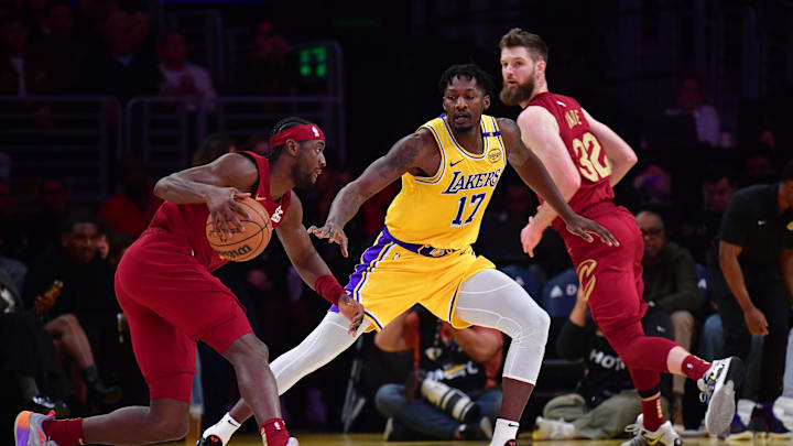 Dec 31, 2024; Los Angeles, California, USA; Los Angeles Lakers forward Dorian Finney-Smith (17) defends against Cleveland Cavaliers guard Caris LeVert (3) during the first half at Crypto.com Arena. Mandatory Credit: Gary A. Vasquez-Imagn Images