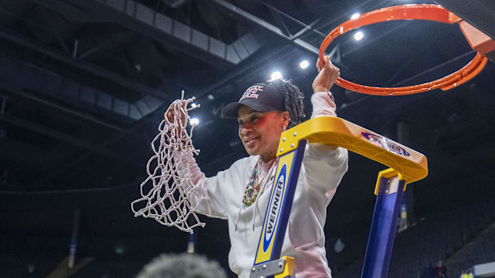Mar 30, 2025; Birmingham, AL, USA; South Carolina Gamecocks head coach Dawn Staley cuts the net after the South Carolina Gamecocks win over the Duke Blue Devils at an Elite 8 NCAA Tournament basketball game at Legacy Arena. Mandatory Credit: Vasha Hunt-Imagn Images