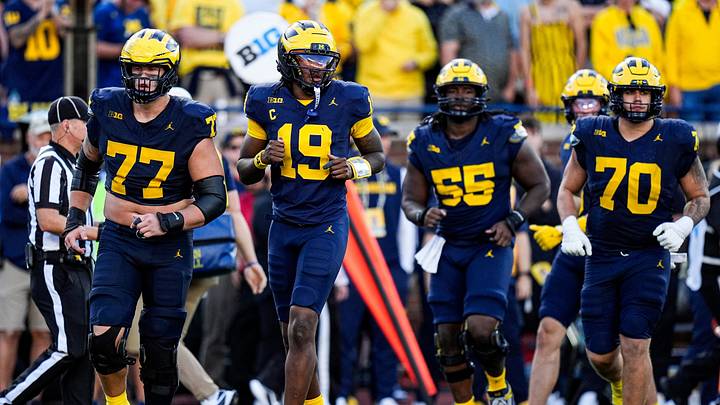 From left, Michigan offensive lineman Blake Frazier (77), quarterback Bryce Underwood (19), offensive lineman Nathan Efobi (55) and offensive lineman Brady Norton (70) run onto the field for a play against Iowa during the second half at Michigan Stadium in Ann Arbor on Saturday, Sept. 26, 2026.