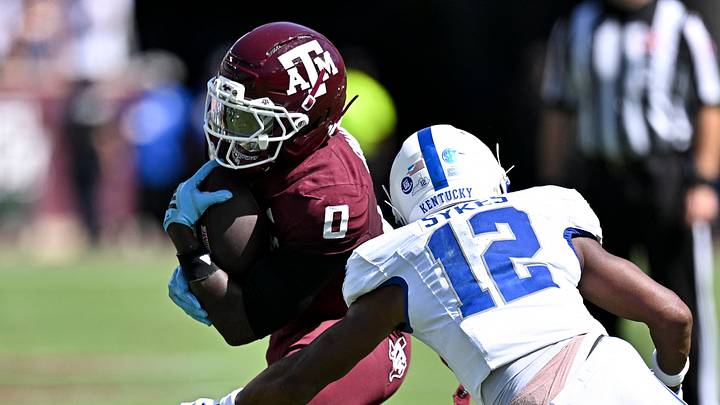 Texas A&M Aggies running back KJ Edwards (0) runs the ball as Kentucky Wildcats defensive back Hasaan Sykes (12) defends at Kyle Field. Texas A&M Aggies running back KJ Edwards (0) runs the ball as Kentucky Wildcats defensive back Hasaan Sykes (12) defends at Kyle Field.
