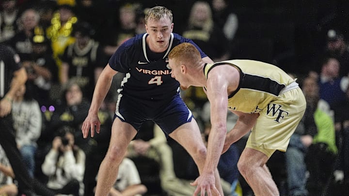 Feb 26, 2025; Winston-Salem, North Carolina, USA; Virginia Cavaliers guard Andrew Rohde (4) on defense against Wake Forest Demon Deacons guard Cameron Hildreth (6) during the second half at Lawrence Joel Veterans Memorial Coliseum. Mandatory Credit: Jim Dedmon-Imagn Images