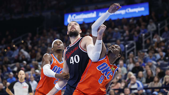 Nov 11, 2024; Oklahoma City, Oklahoma, USA; Los Angeles Clippers center Ivica Zubac (40) and Oklahoma City Thunder guard Shai Gilgeous-Alexander (2) and forward Jalen Williams (8) fight for a rebound during the fourth quarter at Paycom Center. Mandatory Credit: Alonzo Adams-Imagn Images