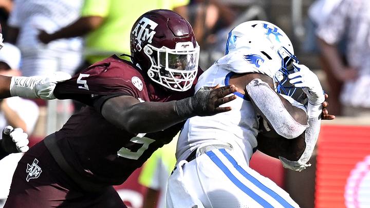 Sep 19, 2026; College Station, Texas, USA;  Texas A&M Aggies defensive tackle DJ Hicks (5) tackles Kentucky Wildcats running back CJ Baxter (1) during the third quarter at Kyle Field. Mandatory Credit: Maria Lysaker-Imagn Images