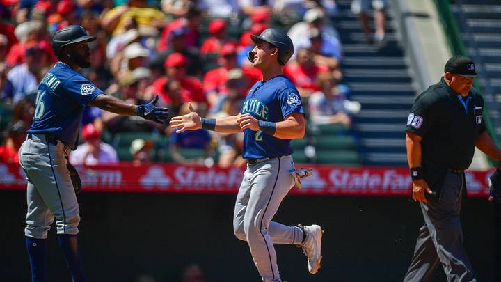 Apr 5, 2026; Anaheim, California, USA; Seattle Mariners second baseman Cole Young (2) is greeted by left fielder Randy Arozarena (56) after both score runs against the Los Angeles Angels during the second inning at Angel Stadium. Mandatory Credit: Gary A. Vasquez-Imagn Images