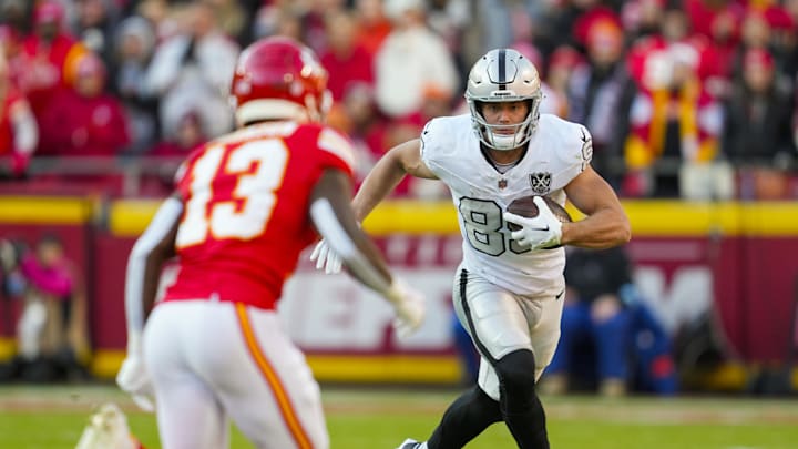 Nov 29, 2024; Kansas City, Missouri, USA; Las Vegas Raiders tight end Brock Bowers (89) runs with the ball against Kansas City Chiefs safety Nazeeh Johnson (13) during the first half at GEHA Field at Arrowhead Stadium. Mandatory Credit: Jay Biggerstaff-Imagn Images