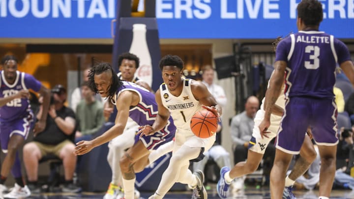 Feb 25, 2025; Morgantown, West Virginia, USA; West Virginia Mountaineers guard Joseph Yesufu (1) steals the ball during the first half against the TCU Horned Frogs at WVU Coliseum. Mandatory Credit: Ben Queen-Imagn Images