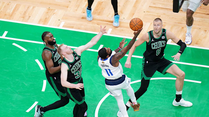 Jun 9, 2024; Boston, Massachusetts, USA; Dallas Mavericks guard Kyrie Irving (11) shoots against Boston Celtics center Kristaps Porzingis (8) and forward Sam Hauser (30) in the first quarter during game two of the 2024 NBA Finals at TD Garden. Mandatory Credit: David Butler II-Imagn Images