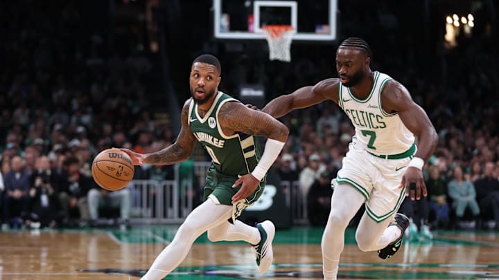 Oct 28, 2024; Boston, Massachusetts, USA; Milwaukee Bucks guard Damian Lillard (0) dribbles down the court defended by Boston Celtics forward Jaylen Brown (7) during the first half at TD Garden. Mandatory Credit: Paul Rutherford-Imagn Images