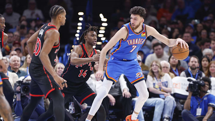Feb 7, 2025; Oklahoma City, Oklahoma, USA; Oklahoma City Thunder forward Chet Holmgren (7) moves the ball against Toronto Raptors guard JaKobe Walter (14) during the second half at Paycom Center. Mandatory Credit: Alonzo Adams-Imagn Images