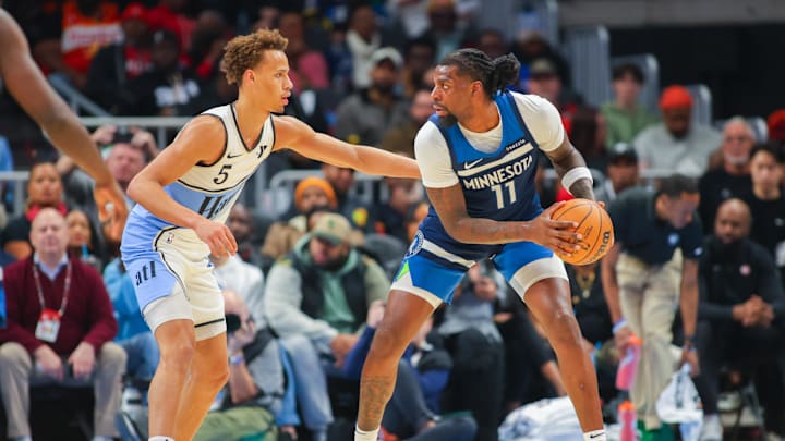 Dec 23, 2024; Atlanta, Georgia, USA; Atlanta Hawks guard Dyson Daniels (5) defends Minnesota Timberwolves center Naz Reid (11) in the second quarter at State Farm Arena. Mandatory Credit: Brett Davis-Imagn Images