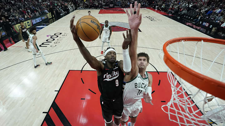 Jan 28, 2025; Portland, Oregon, USA; Portland Trail Blazers small forward Jerami Grant (9) shoots the ball against Milwaukee Bucks center Brook Lopez (11) during the second half at Moda Center. Mandatory Credit: Soobum Im-Imagn Images