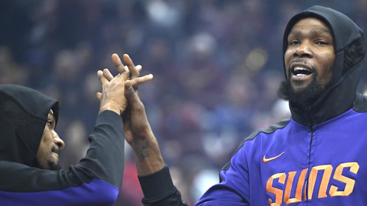 Jan 20, 2025; Cleveland, Ohio, USA; Phoenix Suns forward Kevin Durant (right) reacts during introductions before a game against the Cleveland Cavaliers at Rocket Mortgage FieldHouse. Mandatory Credit: David Richard-Imagn Images