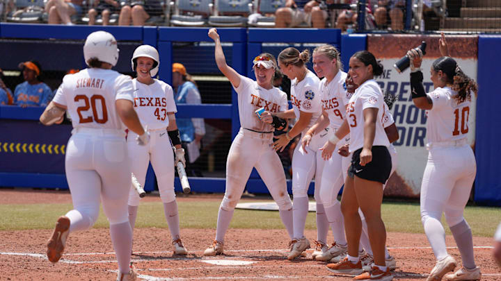 Texas players greet Katie Stewart (20) at home after she hit a home run in the fourth inning of a Women's College World Series softball game between the Tennessee Volunteers and the Texas Longhorns at Devon Park in Oklahoma City, Monday, June 2, 2025. Texas won 2-0. Texas players greet Katie Stewart (20) at home after she hit a home run in the fourth inning of a Women's College World Series softball game between the Tennessee Volunteers and the Texas Longhorns at Devon Park in Oklahoma City, Monday, June 2, 2025. Texas won 2-0.