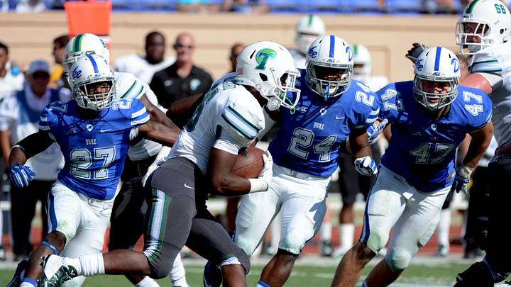 Sep 20, 2014; Durham, NC, USA; Tulane Green Wave running back Dontrell Hilliard (26) runs the ball during the second half as Duke Blue Devils safety DeVon Edwards (27) linebacker Zavier Carmichael (24) and linebacker David Helton (47) pursue at Wallace Wade Stadium. Duke won 47-13. Mandatory credit: Rob Kinnan-USA Today. Sep 20, 2014; Durham, NC, USA; Tulane Green Wave running back Dontrell Hilliard (26) runs the ball during the second half as Duke Blue Devils safety DeVon Edwards (27) linebacker Zavier Carmichael (24) and linebacker David Helton (47) pursue at Wallace Wade Stadium. Duke won 47-13. Mandatory credit: Rob Kinnan-USA Today.
