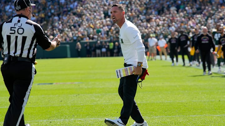Green Bay Packers head coach Matt LaFleur argues a call on a muffed punt with field judge Aaron Santi (50) during the second quarter of their game against the Minnesota Vikings Sunday, September 29, 2024 at Lambeau Field in Green Bay, Wisconsin.