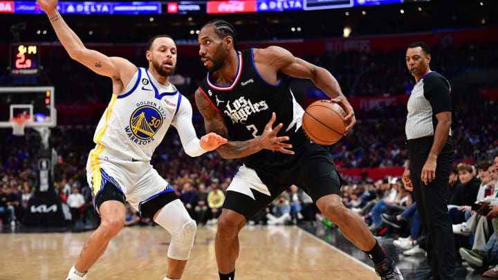 Mar 15, 2023; Los Angeles, California, USA; Los Angeles Clippers forward Kawhi Leonard (2) controls the ball against Golden State Warriors guard Stephen Curry (30) during the second half at Crypto.com Arena. Mandatory Credit: Gary A. Vasquez-USA TODAY Sports