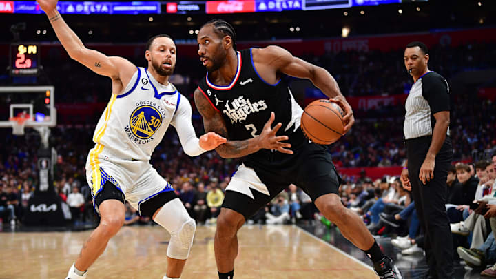 Mar 15, 2023; Los Angeles, California, USA; Los Angeles Clippers forward Kawhi Leonard (2) controls the ball against Golden State Warriors guard Stephen Curry (30) during the second half at Crypto.com Arena. Mandatory Credit: Gary A. Vasquez-Imagn Images