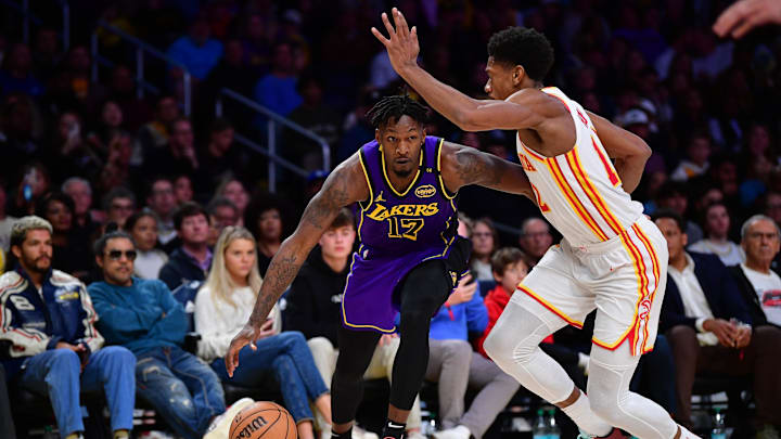Jan 3, 2025; Los Angeles, California, USA; Los Angeles Lakers forward Dorian Finney-Smith (17) moves the ball against Atlanta Hawks forward De'Andre Hunter (12) during the second half at Crypto.com Arena. Mandatory Credit: Gary A. Vasquez-Imagn Images