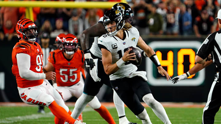 Jacksonville Jaguars quarterback Trevor Lawrence (16) spins out of pressure in the fourth quarter