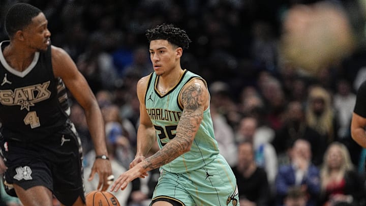 Feb 7, 2025; Charlotte, North Carolina, USA; Charlotte Hornets guard KJ Simpson (25) brings the ball up court on a steal defended by San Antonio Spurs guard De'Aaron Fox (4) during the second quarter at Spectrum Center. Mandatory Credit: Jim Dedmon-Imagn Images