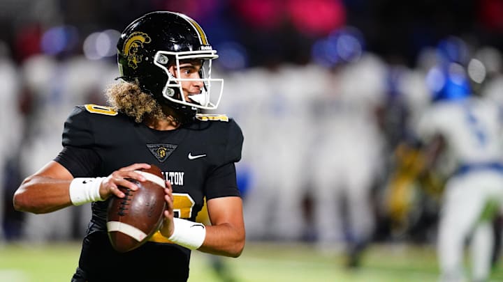 Oct 20, 2023; Carrollton, GA, USA; Carrollton Trojans quarterback Julian Lewis (10) drops back to pass against the Westlake Lions during the first half at Grisham Stadium. The 15-year-old Carrollton High student has already committed to playing for the University of Southern California Trojans and has been considered one of the top high school quarterback prospects. Mandatory Credit: John David Mercer-Imagn Images