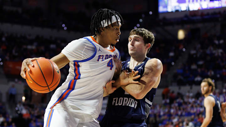 Florida Gators forward Sam Alexis (4) posts up against North Florida Ospreys guard Nate Lliteras (2) during the second half at Exactech Arena at the Stephen C. O'Connell Center. Florida Gators forward Sam Alexis (4) posts up against North Florida Ospreys guard Nate Lliteras (2) during the second half at Exactech Arena at the Stephen C. O'Connell Center.