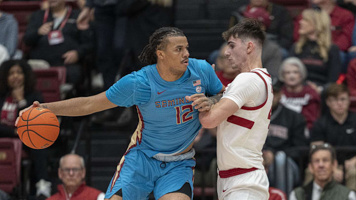 Jan 25, 2025; Stanford, California, USA; Florida State Seminoles forward Malique Ewin (12) collides with Stanford Cardinal forward Maxime Raynaud (right) during the first half at Maples Pavilion. Mandatory Credit: Stan Szeto-Imagn Images Jan 25, 2025; Stanford, California, USA; Florida State Seminoles forward Malique Ewin (12) collides with Stanford Cardinal forward Maxime Raynaud (right) during the first half at Maples Pavilion. Mandatory Credit: Stan Szeto-Imagn Images