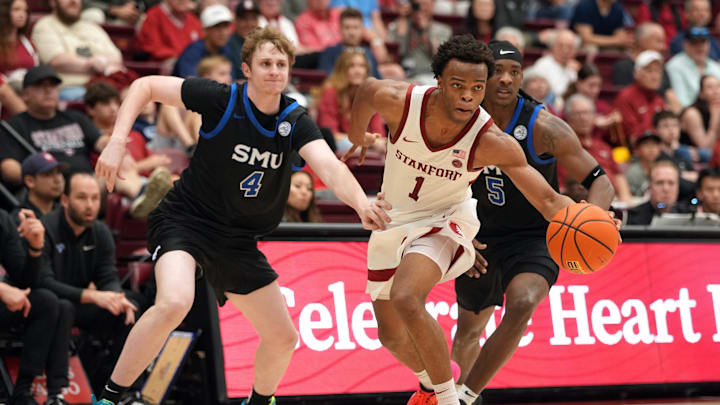 Feb 28, 2026; Stanford, California, USA; Stanford Cardinal guard Ebuka Okorie (1) dribbles against Southern Methodist University Mustangs forward Sam Walters (4) and guard Jaron Pierre Jr. (5) during the first half at Maples Pavilion. Mandatory Credit: Darren Yamashita-Imagn Images
