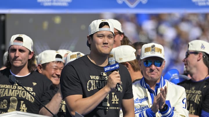 Los Angeles Dodgers owner Stan Kasten applauds, designated hitter Shohei Ohtani (17) to speaks to fans, in english, during the World Series Championship Celebration at Dodger Stadium on Nov 1.