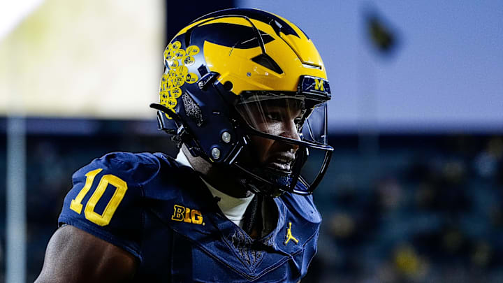 Michigan quarterback Alex Orji (10) warms up before the Michigan State game at Michigan Stadium in Ann Arbor on Saturday, Oct. 26, 2024.