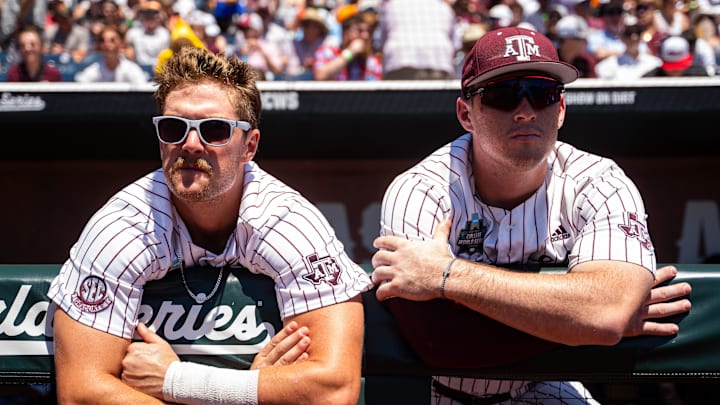 Jun 23, 2024; Omaha, NE, USA; Texas A&M Aggies designated hitter Hayden Schott (5) and infielder Ryan Targac (12) before game 2 of the College Baseball World Series against the Tennessee Volunteers at Charles Schwab Field Omaha. Mandatory Credit: Dylan Widger-USA TODAY Sports