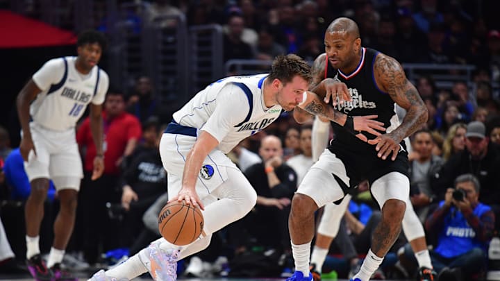 Dallas Mavericks guard Luka Doncic (77) against Los Angeles Clippers forward P.J. Tucker (17) during the first half at Crypto.com Arena. 