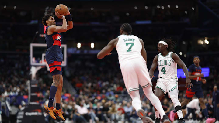 Nov 22, 2024; Washington, District of Columbia, USA; Washington Wizards guard Jordan Poole (13) shoots the ball as Boston Celtics guard Jaylen Brown (7) and Celtics guard Jrue Holiday (4) look on in the second half at Capital One Arena. Mandatory Credit: Geoff Burke-Imagn Images