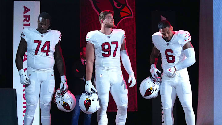 Cardinals players D.J. Humphries (74), Cameron Thomas (97), and James Conner (6) pose for pictures