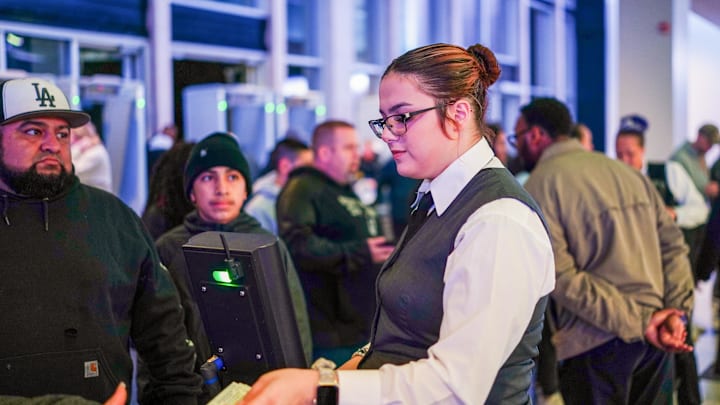 Jan 24, 2024; San Antonio, Texas, USA;  A Frost Bank Center employee helps fans enter before the game between the San Antonio Spurs and Oklahoma City Thunder. Mandatory Credit: Daniel Dunn-Imagn Images