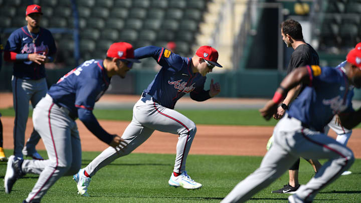 Atlanta Braves infielder Jarred Kelenic (#24) and his teammates run sprints at the start of practice