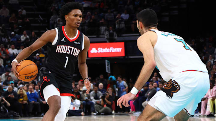 Jan 30, 2025; Memphis, Tennessee, USA; Houston Rockets forward Amen Thompson (1) dribbles as Memphis Grizzlies forward Santi Aldama (7) defends during the fourth quarter at FedExForum. Mandatory Credit: Petre Thomas-Imagn Images