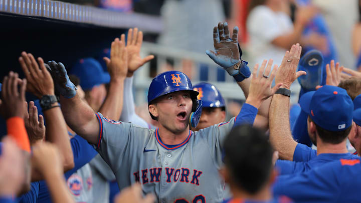Apr 2, 2025; Miami, Florida, USA; New York Mets first baseman Pete Alonso (20) celebrates with teammates after hitting a three-run home run against the Miami Marlins during the eighth inning at loanDepot Park. Mandatory Credit: Sam Navarro-Imagn Images