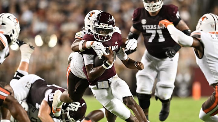 Sep 21, 2024; College Station, Texas, USA; Texas A&M Aggies quarterback Marcel Reed (10) runs the ball as Bowling Green Falcons defensive lineman Jordan Porter (33) defends during the second quarter at Kyle Field. Mandatory Credit: Maria Lysaker-Imagn Images. 