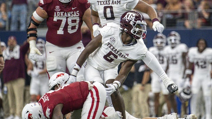 Sep 30, 2023; Arlington, Texas, USA; Texas A&M Aggies defensive lineman Enai White (6) and Arkansas Razorbacks quarterback KJ Jefferson (1) In action during the game between the Texas A&M Aggies and the Arkansas Razorbacks at AT&T Stadium. Mandatory Credit: Jerome Miron-Imagn Images
