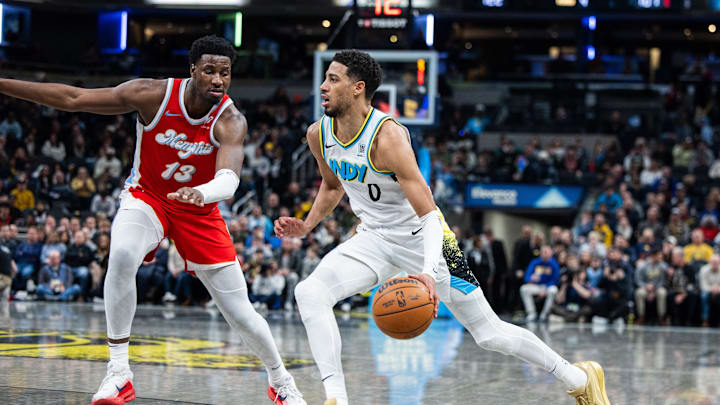 Feb 20, 2025; Indianapolis, Indiana, USA; Indiana Pacers guard Tyrese Haliburton (0) dribbles the ball while Memphis Grizzlies forward Jaren Jackson Jr. (13) defends in the second half at Gainbridge Fieldhouse. Mandatory Credit: Trevor Ruszkowski-Imagn Images