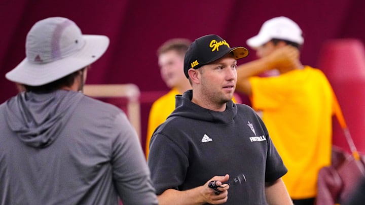 Arizona State head coach Kenny Dillingham talks with assistant coaches during a practice at the Verde Dickey Dome in Tempe on Aug. 19, 2025.