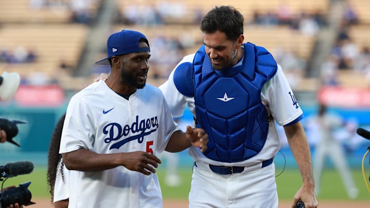 May 17, 2024; Los Angeles, California, USA;  Former NFL and University of Southern California running back Reggie Bush chats with former USC teammate and quarterback Matt Leinart after throwing out the ceremonial first pitch prior to the MLB game between the Los Angeles Dodgers and the Cincinnati Reds at Dodger Stadium. Mandatory Credit: Kiyoshi Mio-Imagn Images